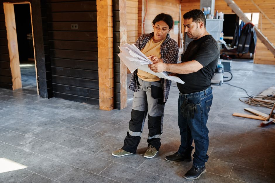 Contractor carefully measuring during a bathroom remodeling project